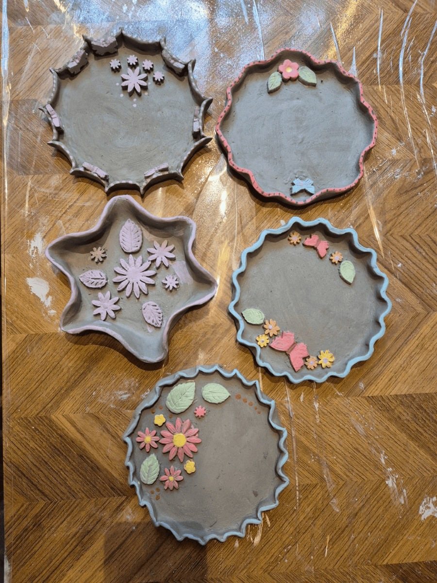 Hand-built plates with painted flowers