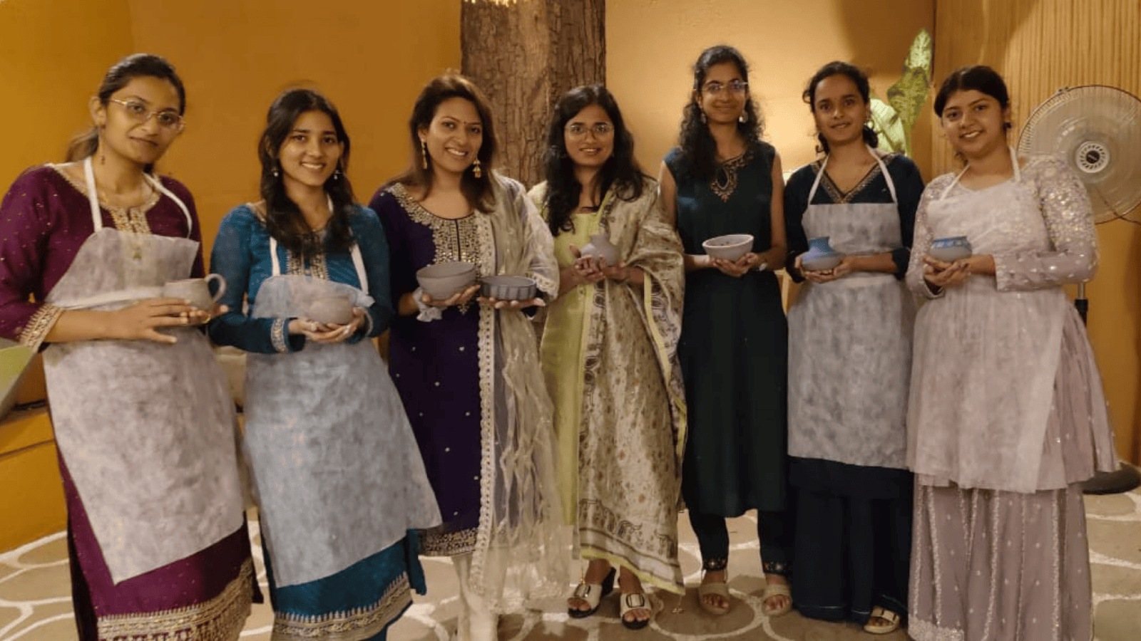 A group of friends with their finished pottery